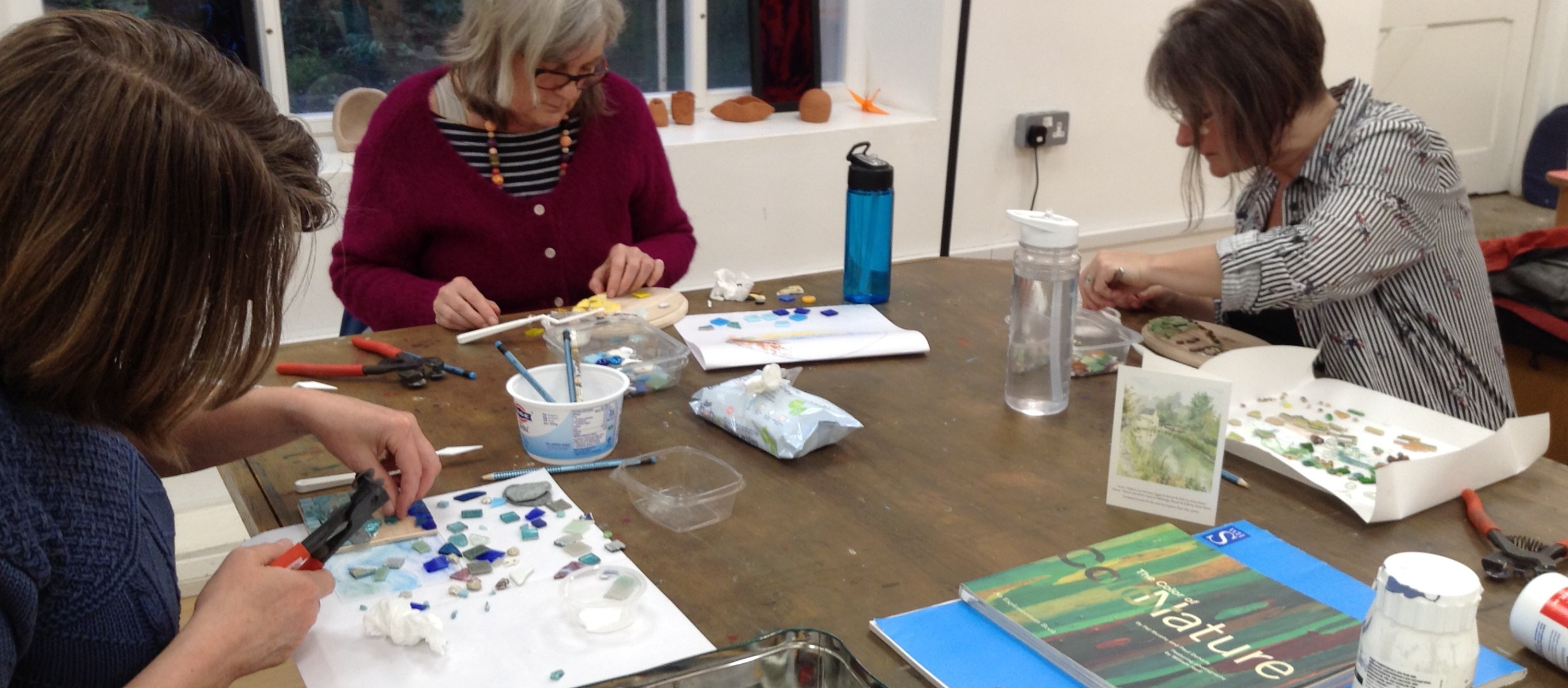 Participants doing mosaic at the Imagine Therapeutic Arts Studio 