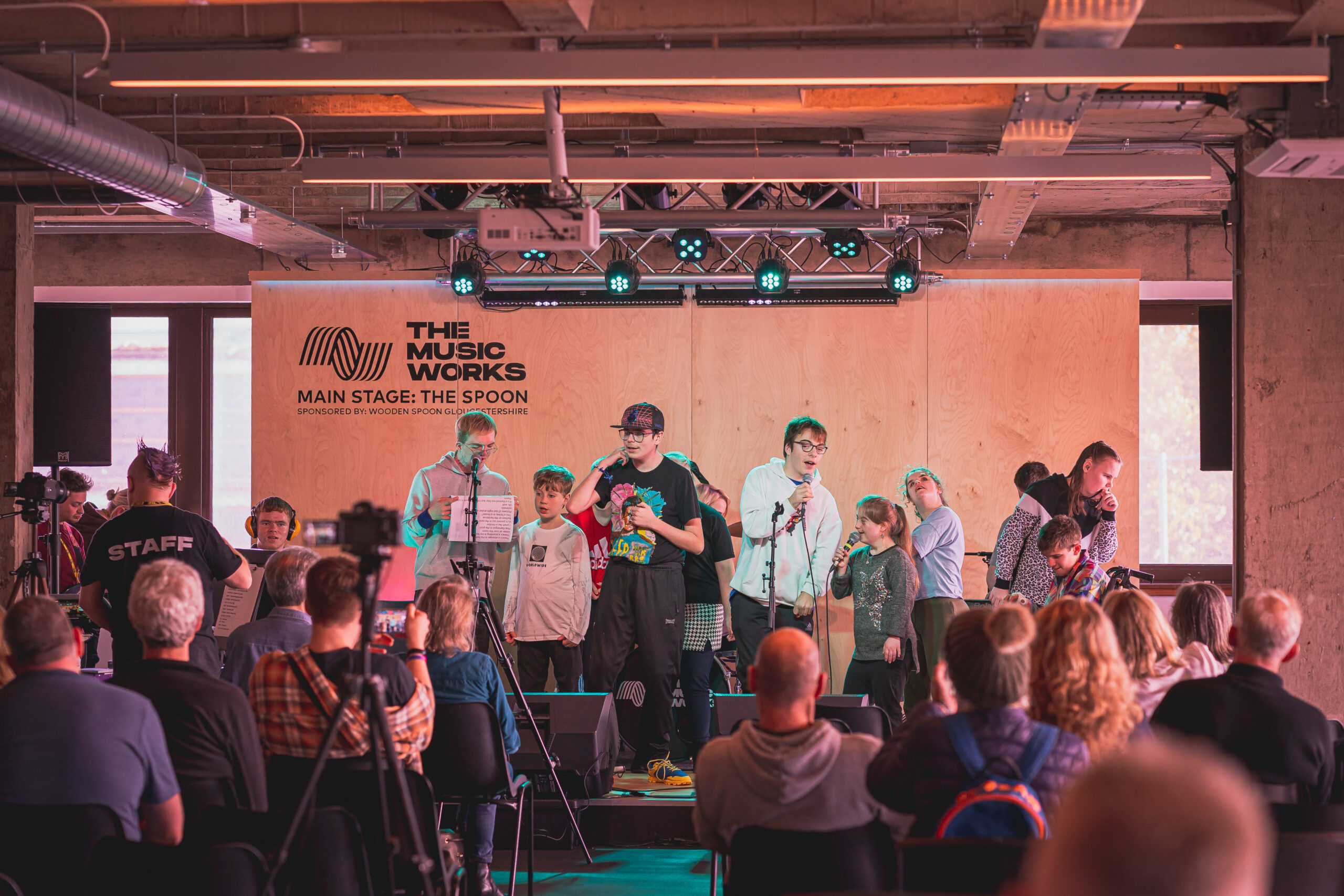 Mix & Mash end of week performance February 2023, this picture is of a group of young disabled performers preparing to sing their final song on stage.