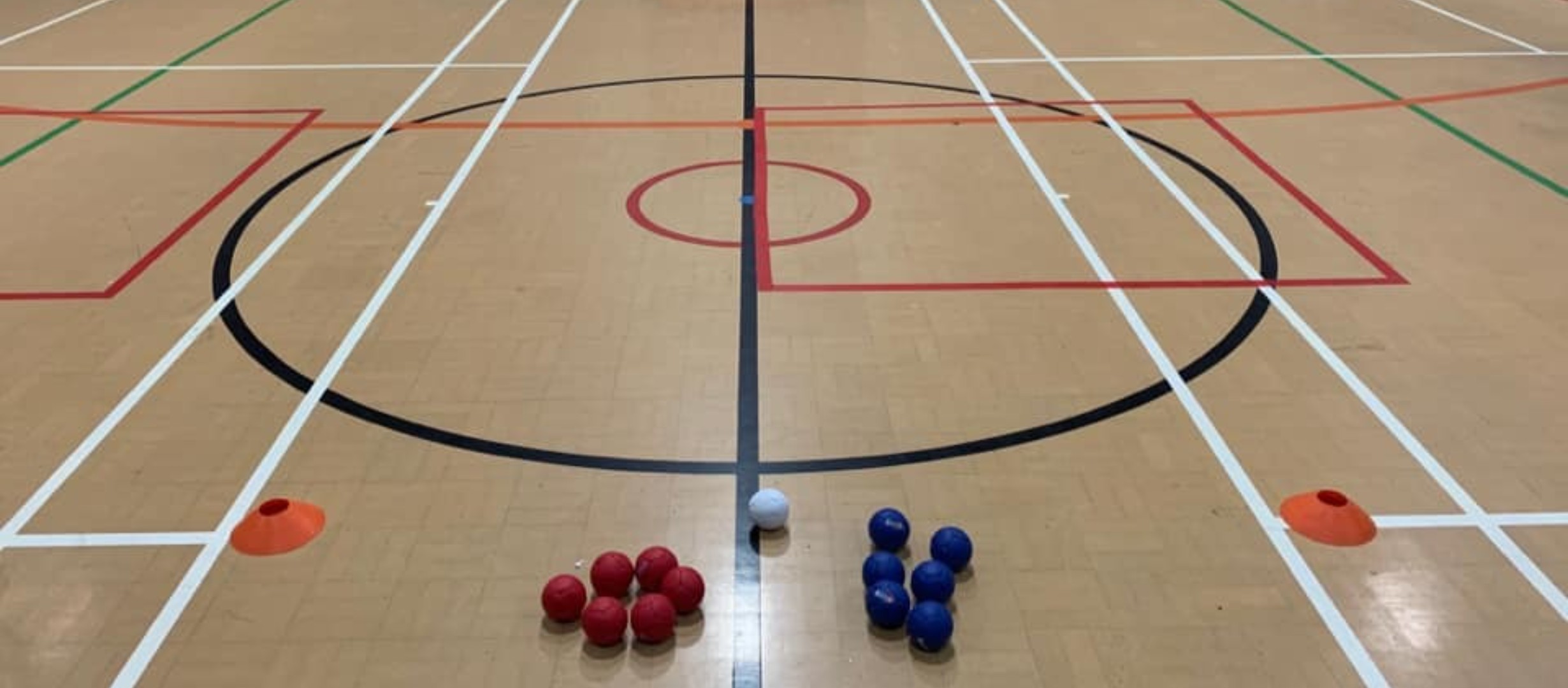 photo of sports hall floor with boccia balls and cones