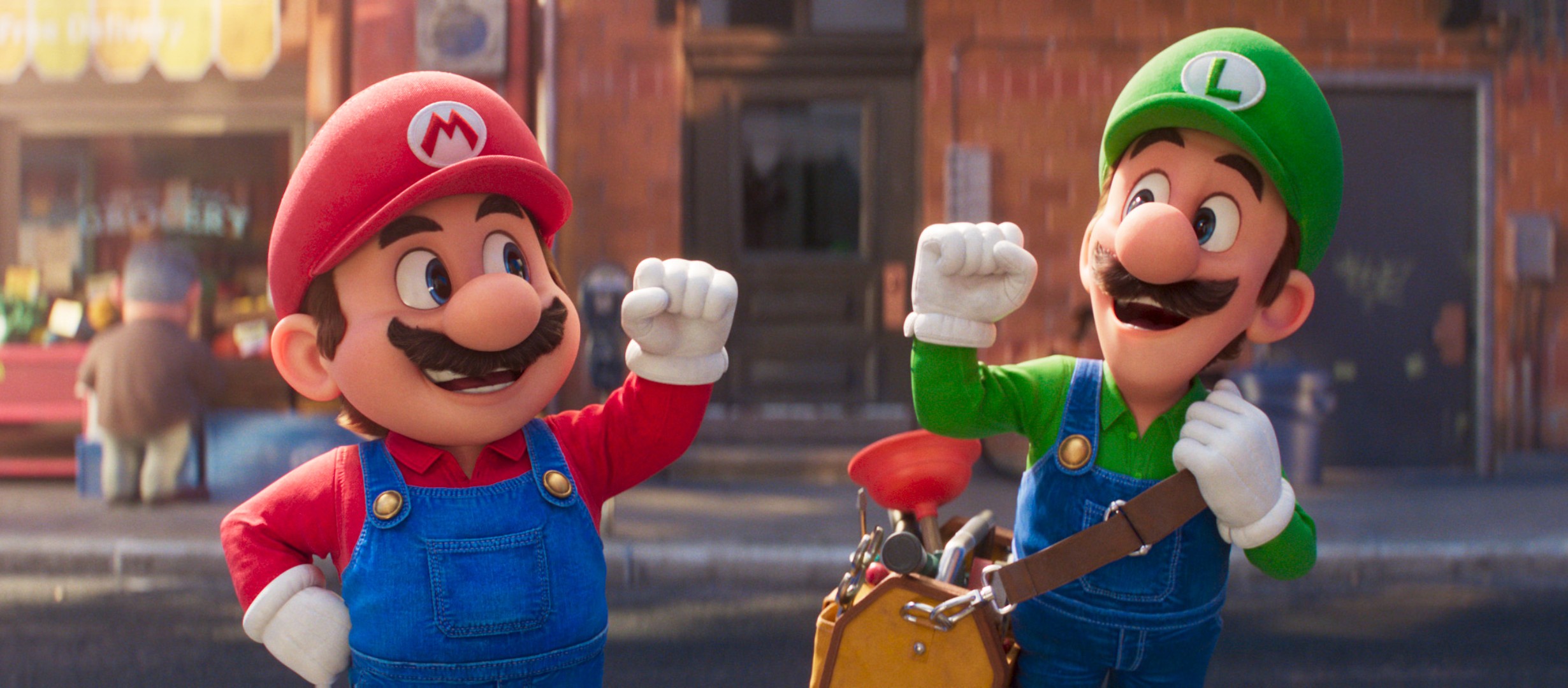 Mario and Luigi smiling throwing their fist in the air in celebration