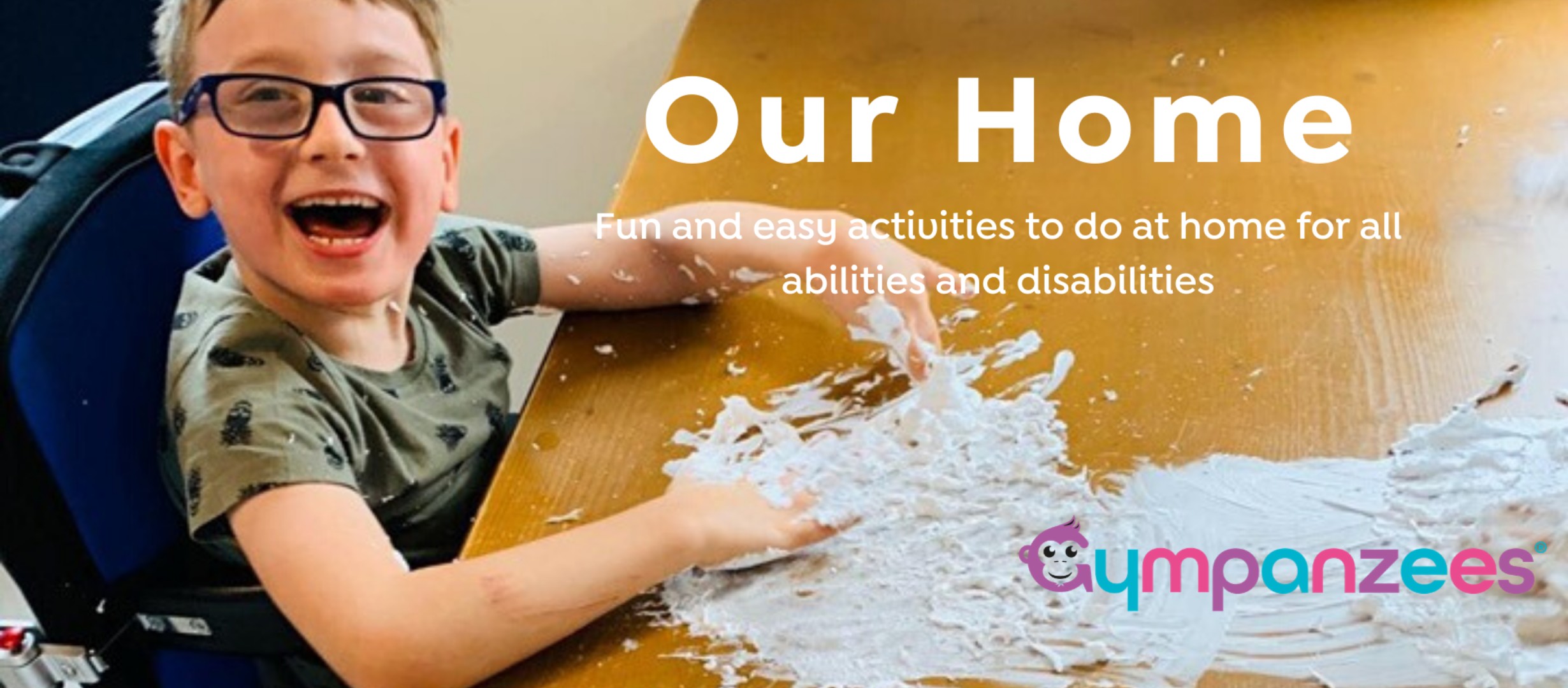 young boy in wheelchair looking very happy doing a craft, text reads 'our home, fun and easy activities to do at home for all abilities and disabilities'
