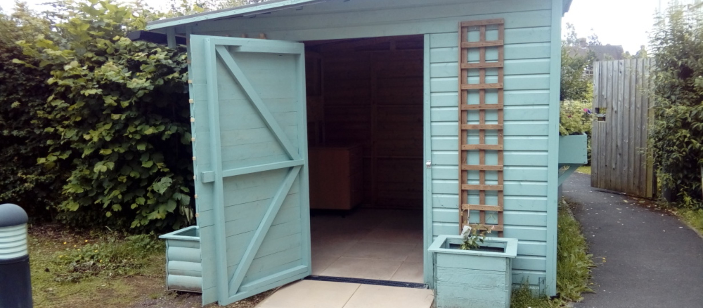 white shed with door open