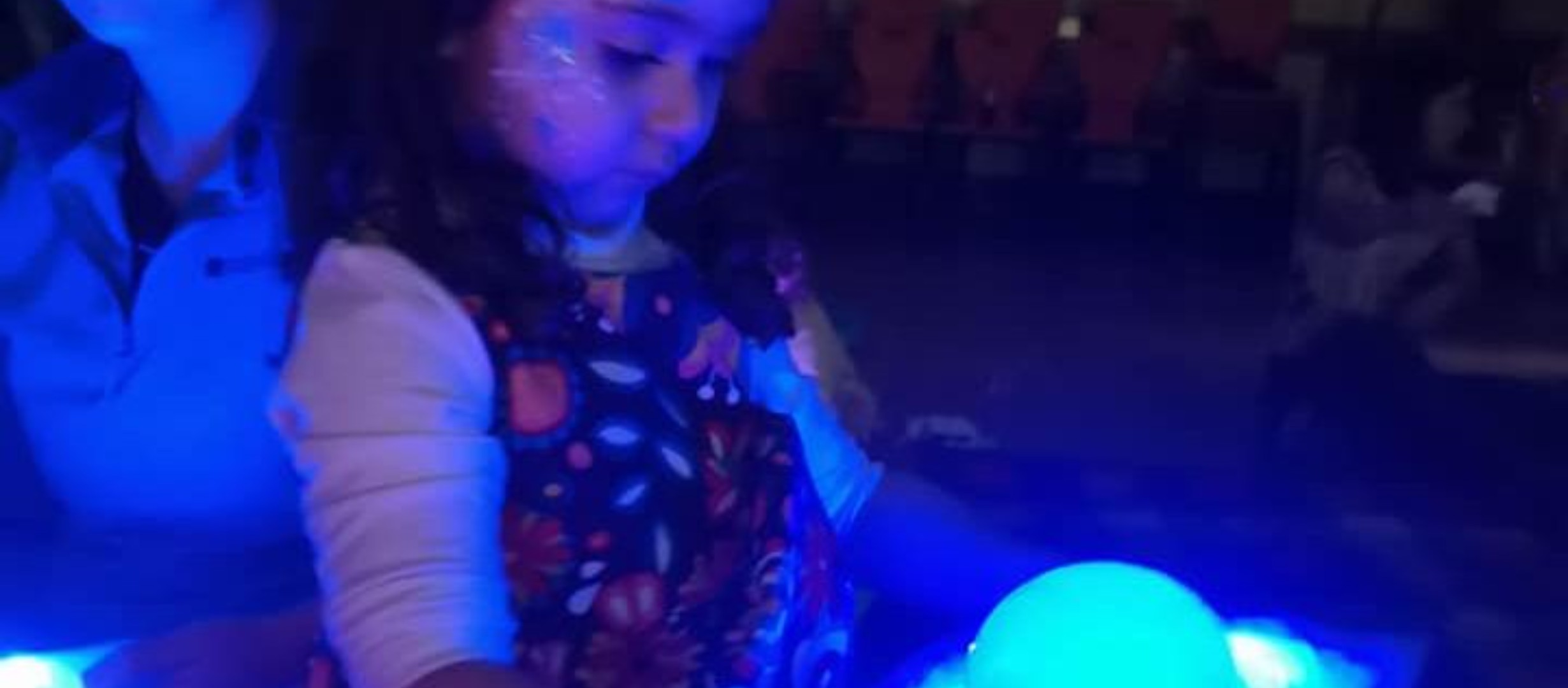 child holding a tray with glowing bubbles