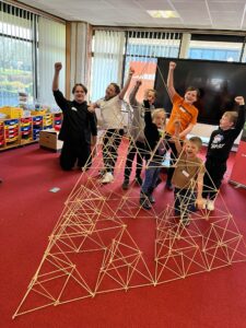 Children with the tall structure they made during a session