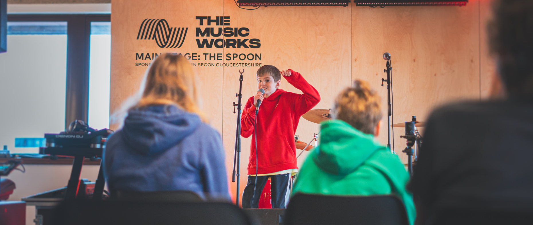 young disabled performer on stage at the Gloucester Hub for the final performance at one of The Music Works' previous Mix & Mash weeks.