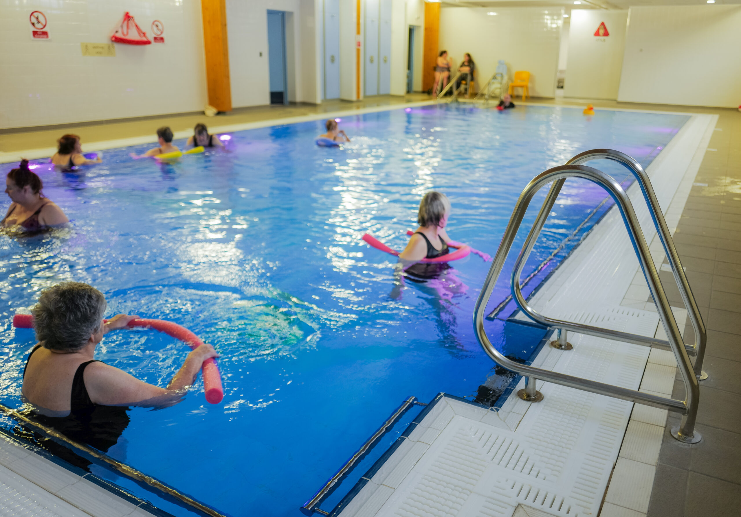 Large hydrotherapy pool with adults and children in the water