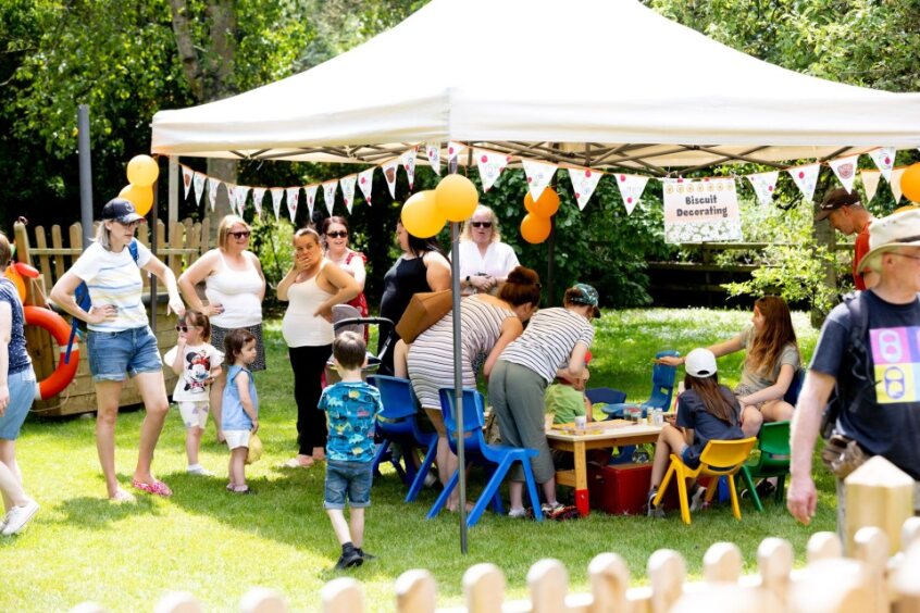 Families in our large garden enjoying craft activities together in the sunshine under gazebos