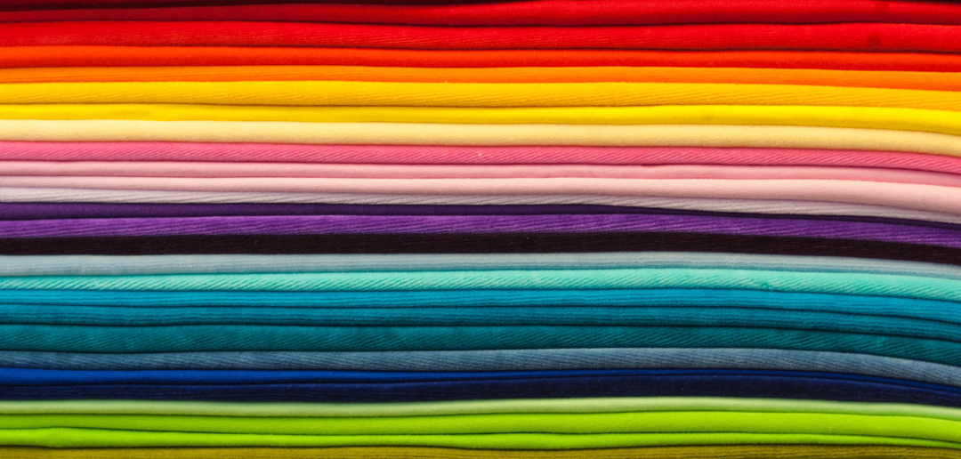 Layers of fabric in vibrant colours. They are arranged to look like a beautiful rainbow