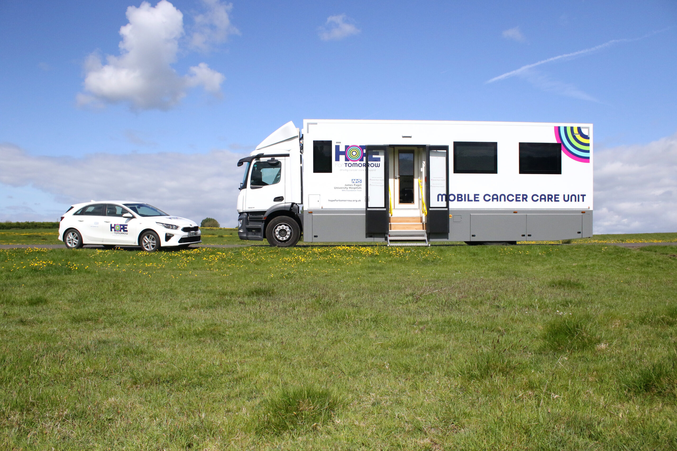 An image of a Hope for Tomorrow nurse support vehicle next to a mobile cancer care unit