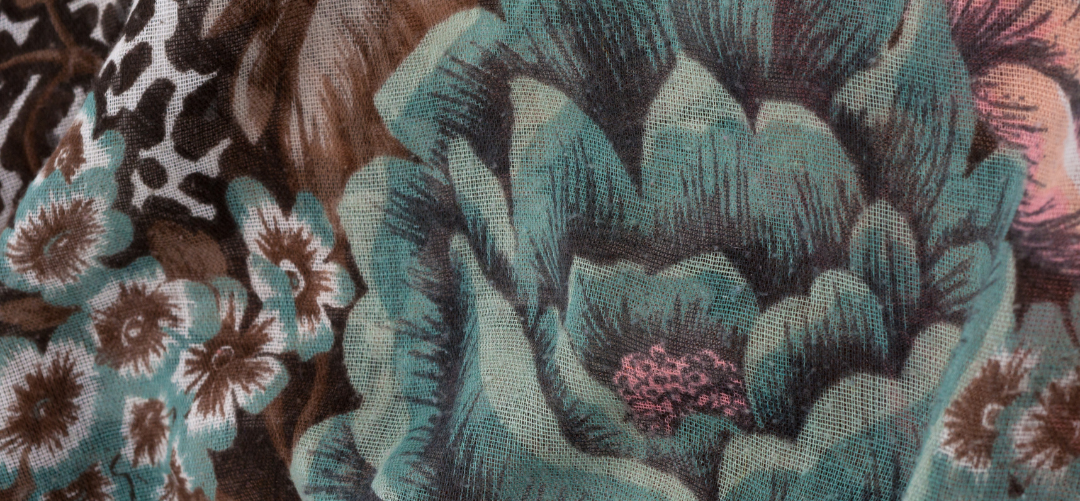 This is an image of a beautiful piece of fabric with a botanical themed pattern involving lots of different flowers