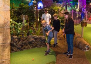 young people playing crazy golf