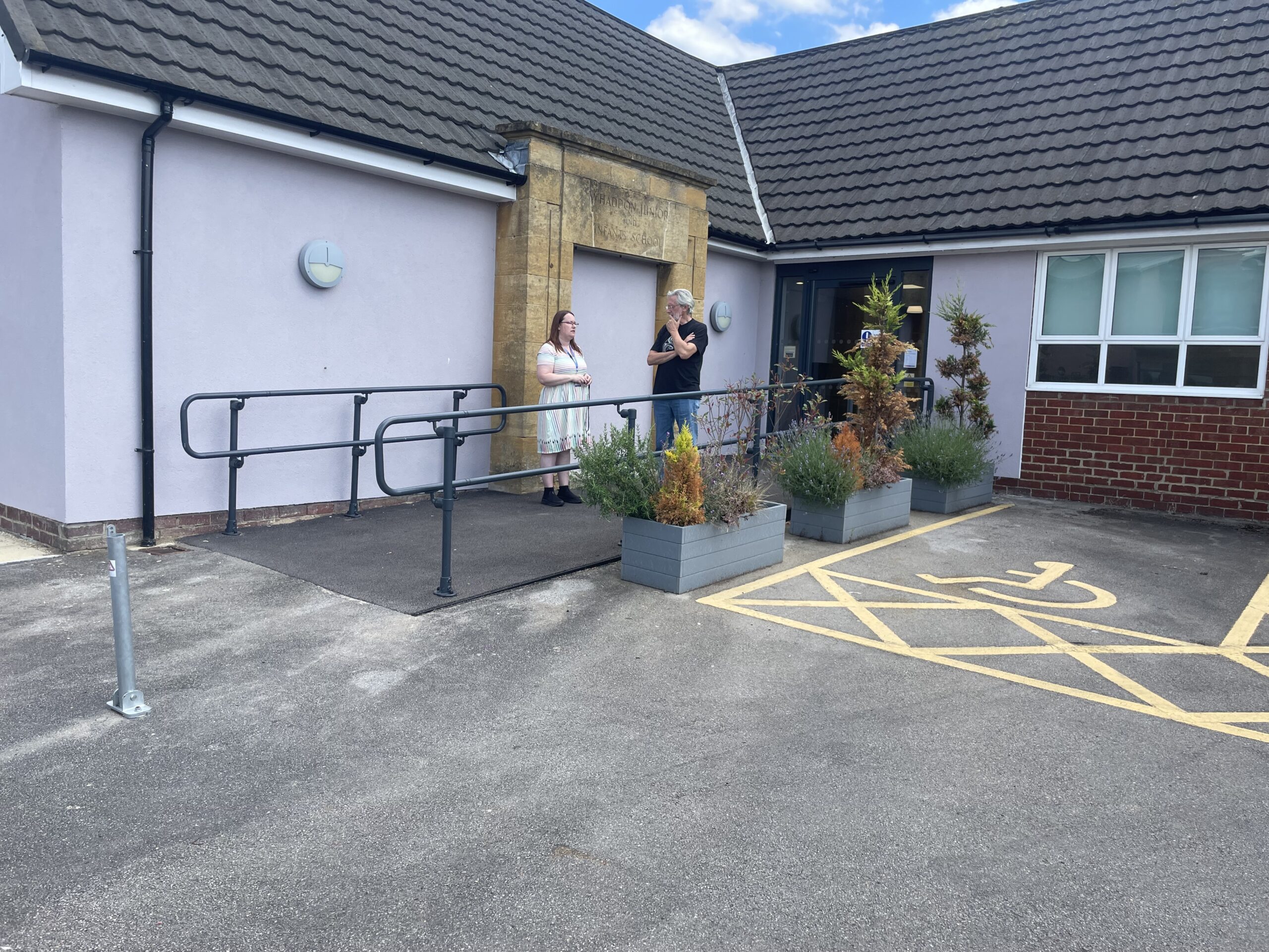 Image shows the entrance of Oakley Library Interactive space with two people stood talking.