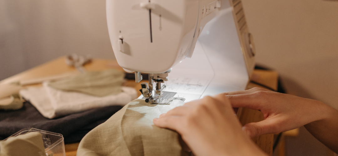 This is a photograph of a woman using a sewing machine