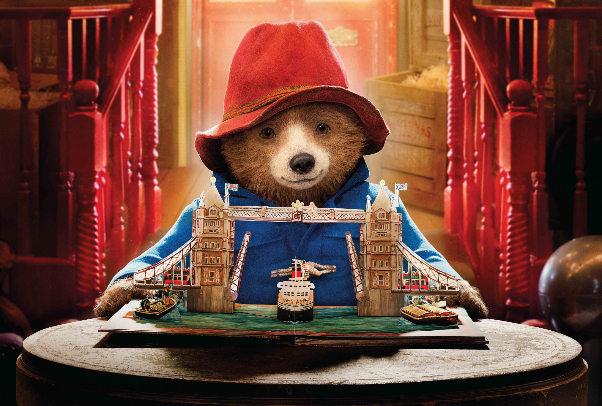 Paddington Bear holding a model of Tower Bridge