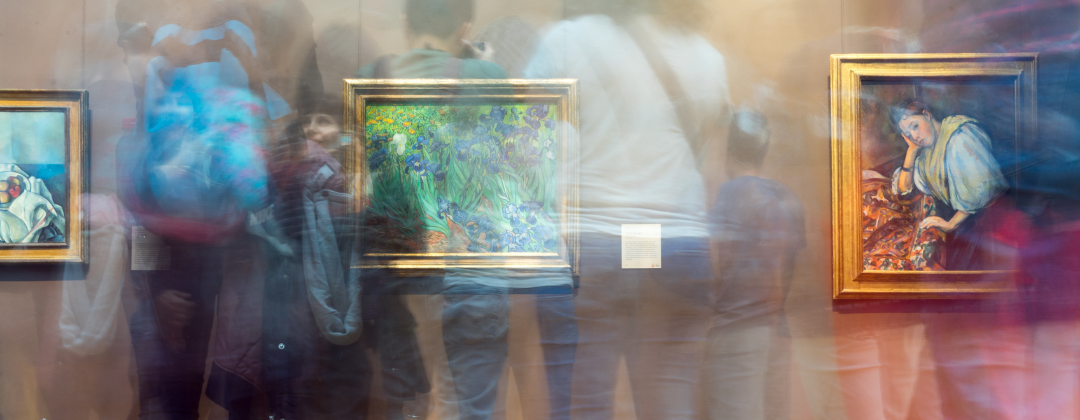 This is a photograph of a gallery with a camera effect over the top of people looking at the paintings