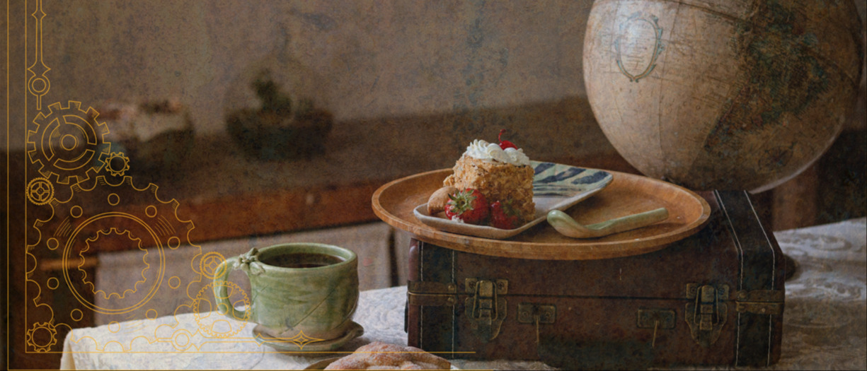 This is a photograph of a piece of cake with strawberries on an antique leather suitcase. There is an antique globe and a cup of tea in a green cup also visible on the table