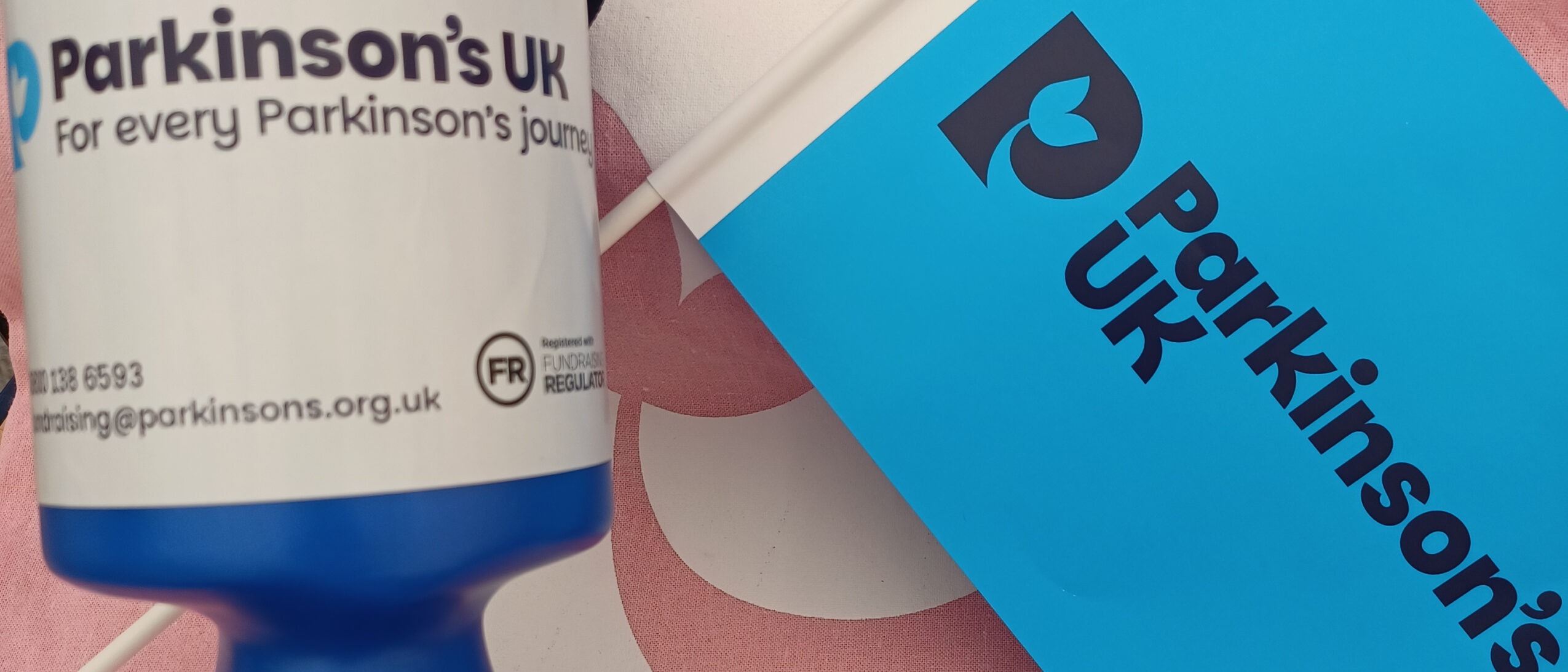 Parkinson's UK flag and collection tin